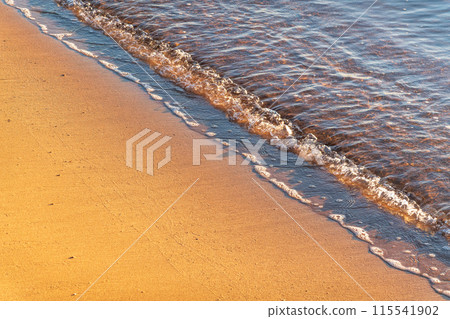 Soft wave of the sea on the sandy beach. Soft wave of the sea on the sandy beach. 115541902