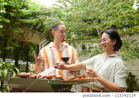 Couple Grilling Meat and Veggies Couple Grilling Meat and Veggies 115542114