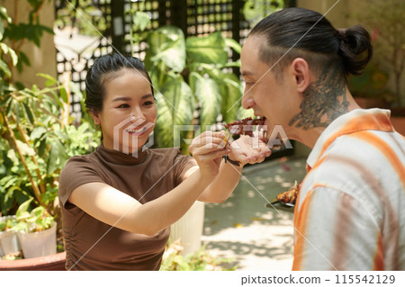 Tasting Grilled Meat 115542129