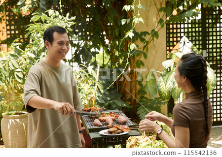 Happy Couple Grilling Food 115542136