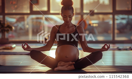 pregnant woman in a peaceful yoga pose, meditating with serenity and grace. 115542368