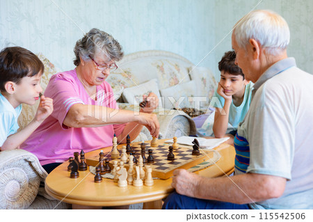 Family playing chess together at home Family playing chess together at home 115542506