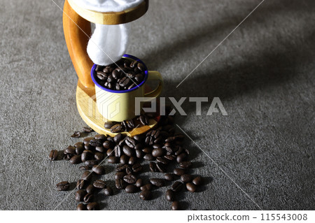 Coffee beans and a filter dripper on a gray stone background 115543008