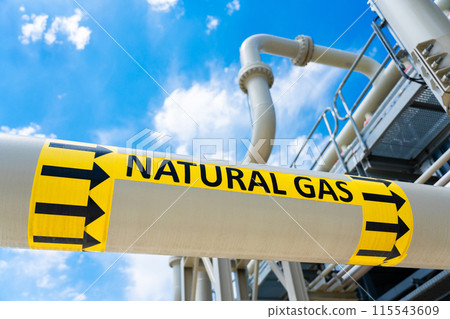 High pressure gas pipeline with flow direction sign at compressor station. Concept of industrial energy supply system 115543609
