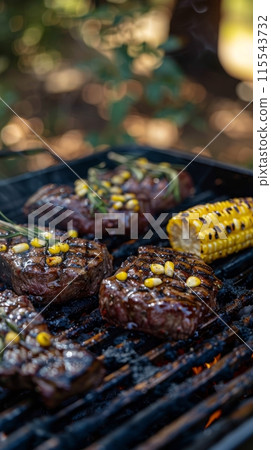 Grilled Steaks and Corn on the Grill. Juicy steaks and corn on the cob grilling over an open flame, perfect for a summer barbecue feast. 115543732