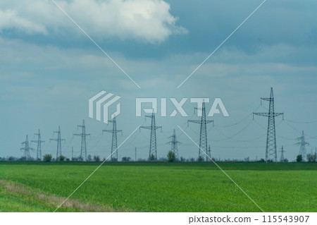 High voltage towers with sky background. Power line support with wires for electricity transmission. High voltage grid tower with wire cable at distribution station. Energy industry, energy saving High voltage towers with sky background. Power line support with wires for electricity transmission. High voltage grid tower with wire cable at distribution station. Energy industry, energy saving 115543907