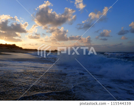 Waves break on shore of Hanakailio Beach with dramatic blue-pink cloudy skyline at dusk Waves break on shore of Hanakailio Beach with dramatic blue-pink cloudy skyline at dusk 115544339