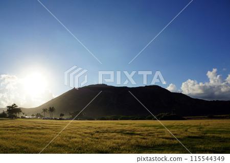 Sunset over Sandy Beach Park grass field and Koko Head Crater Sunset over Sandy Beach Park grass field and Koko Head Crater 115544349