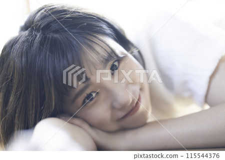 A woman surrounded by gentle light 115544376