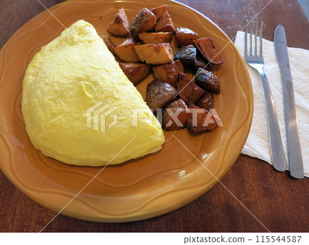 Omelette and Ranch Potatoes on orange platet 115544587