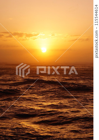 Sunset over the ocean with waves Sunset over the ocean with waves 115544614