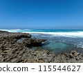 Jagged Coral Rock Shore with waves breaking 115544627
