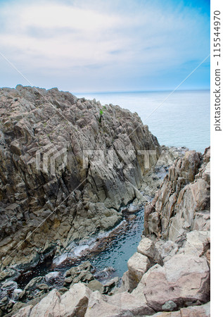 The steep cliffs and sea of Tojinbo on a clear day The steep cliffs and sea of Tojinbo on a clear day 115544970