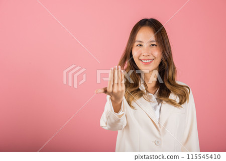 Happy Asian portrait beautiful cute young woman teen smile positive friendly making gesture hand inviting to come here with hand look to camera studio shot isolated on pink background with copy space Happy Asian portrait beautiful cute young woman teen smile positive friendly making gesture hand inviting to come here with hand look to camera studio shot isolated on pink background with copy space 115545410