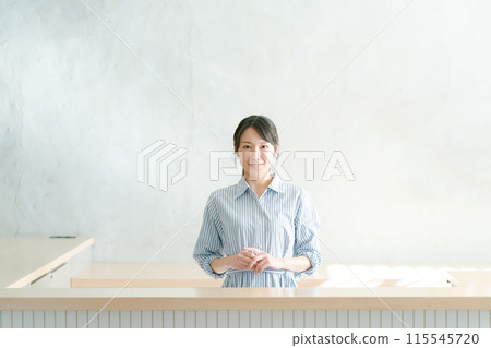 Photo of a woman standing at a counter 115545720