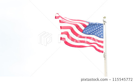 Beautiful American flag waving in the wind, with vibrant red white and blue colors against blue sky, with copy space. Beautiful American flag waving in the wind, with vibrant red white and blue colors against blue sky, with copy space. 115545772