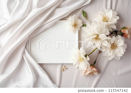 Floral composition. White flowers on white fabric. Flat lay, top view, copy space. Floral composition. White flowers on white fabric. Flat lay, top view, copy space. 115547142