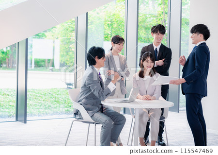 Smiling business people having a meeting in the office 115547469