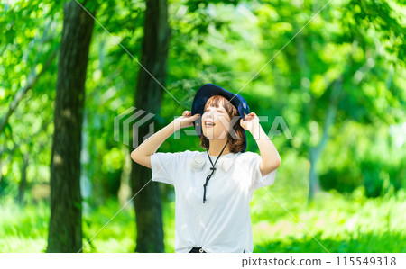 Young woman basking in the sun in nature, outdoors Young woman basking in the sun in nature, outdoors 115549318