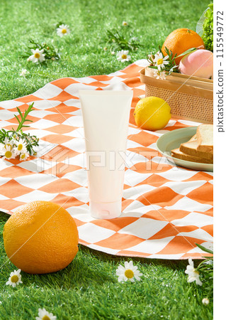 Mockup for design promotional pic of natural cosmetic product, which extract from nature ingredient. In the center of photo frame displays an unbranded tube, some tiny flowers scattered around 115549772