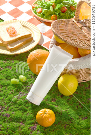Top down photography on an unlabeled cosmetic tube lay on green grass, beside it is some lemons and oranges scattered, a fruit basket, salad dish and some sandwiches. Mock up for advertising Top down photography on an unlabeled cosmetic tube lay on green grass, beside it is some lemons and oranges scattered, a fruit basket, salad dish and some sandwiches. Mock up for advertising 115549783