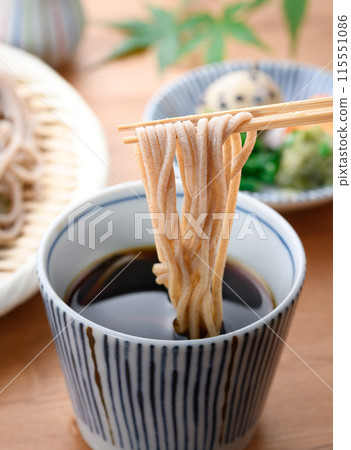 Dip the soba noodles in the soup (condiments include chopped green onion, quail eggs, and wasabi). 115551086