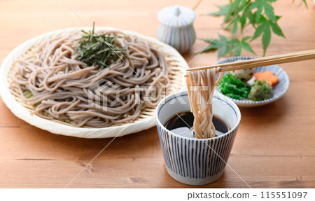 Dip the soba noodles in the soup (condiments include chopped green onion, quail eggs, and wasabi). 115551097