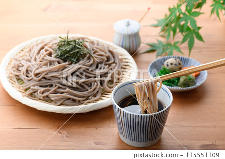 Dip the soba noodles in the soup (condiments include chopped green onion, quail eggs, and wasabi). 115551109