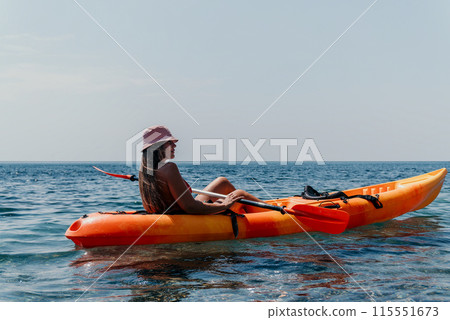 Woman sea kayak. Happy smiling woman paddling in kayak on ocean. Calm sea water and horizon in background. Active lifestyle at sea. Summer vacation. Woman sea kayak. Happy smiling woman paddling in kayak on ocean. Calm sea water and horizon in background. Active lifestyle at sea. Summer vacation. 115551673