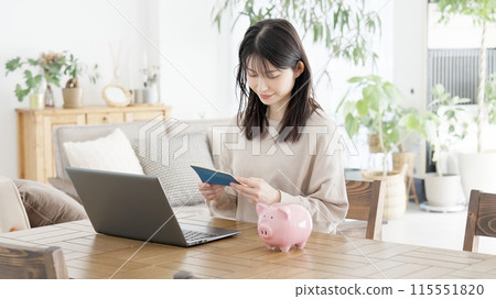 A woman checking her bankbook balance A woman checking her bankbook balance 115551820