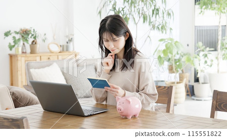 A woman worried about her bankbook balance A woman worried about her bankbook balance 115551822