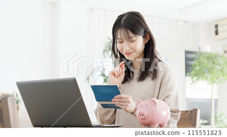 A woman checking her bankbook balance 115551823
