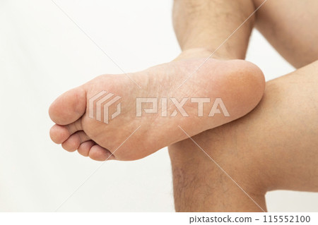 Men's feet on white background 115552100