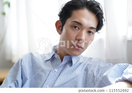 Young man relaxing in the living room Young man relaxing in the living room 115552892