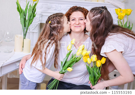 Daughters congratulate their mother on the holiday. Happy Mother's Day. Family holiday and togetherness. 115553193
