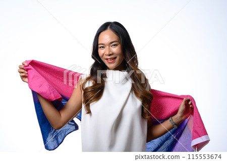 Smiling young woman holding bisexual flag isolate white background. Human rights, freedom and equality concept Smiling young woman holding bisexual flag isolate white background. Human rights, freedom and equality concept 115553674