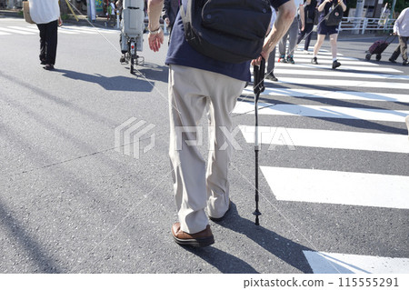 Yokohama cityscape in Japan. Aging society. A man with a cane crossing the street... his body is leaning to the right... = Yokohama city 115555291
