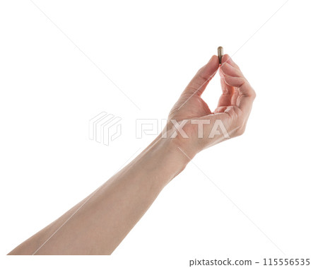 Male hand show brown pill isolated on white Male hand show brown pill isolated on white 115556535