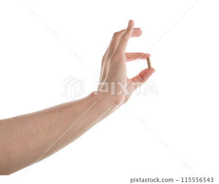 Male hand show brown pill isolated on white Male hand show brown pill isolated on white 115556543
