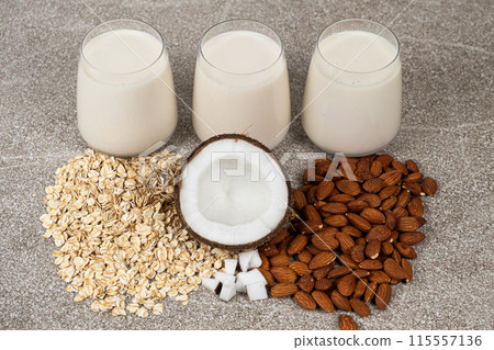 Types of plant-based milk in glasses. Oat, coconut and almond milk. Types of plant-based milk in glasses. Oat, coconut and almond milk. 115557136