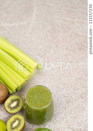 Green smoothie with kiwi, apples, celery, spinach, a healthy natural foods dish, copy space for text Green smoothie with kiwi, apples, celery, spinach, a healthy natural foods dish, copy space for text 115557230