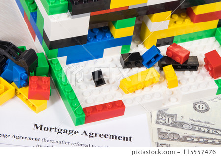 House under construction made of toy blocks, dollars, mortgage agreement form House under construction made of toy blocks, dollars, mortgage agreement form 115557476