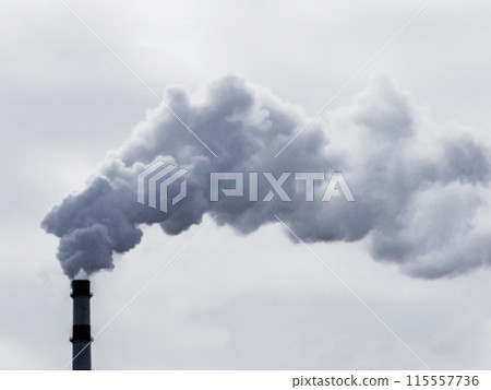 Thick dark smoke from the chimney against the sky. 115557736
