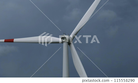 Windmill or wind turbine on wind farm in rotation Windmill or wind turbine on wind farm in rotation 115558290