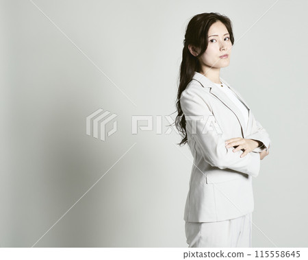 A woman wearing a suit on a white background 115558645
