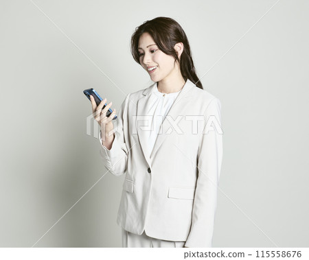 A woman wearing a suit on a white background A woman wearing a suit on a white background 115558676