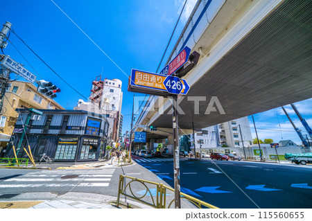 Tokyo cityscape in Japan. The intersection in front of Komazawa Daigaku Station. The west exit of Komazawa Daigaku Station is in the background, and the east exit is in the far right. 115560655