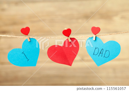 I love dad written on paper hearts on grey background. Happy father's day 115561057