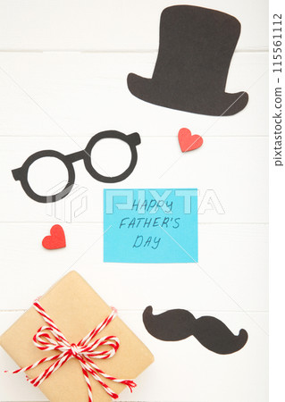 Happy Fathers Day greeting card and gift on white wooden background Happy Fathers Day greeting card and gift on white wooden background 115561112