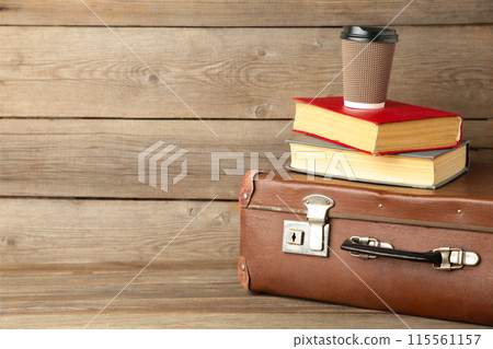 Old suitcase and books with cup of coffee 115561157